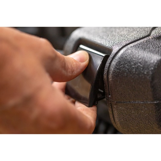 STANLEY STMT82831-1 close-up photo of a hand opening a black latch on a textured tool case.