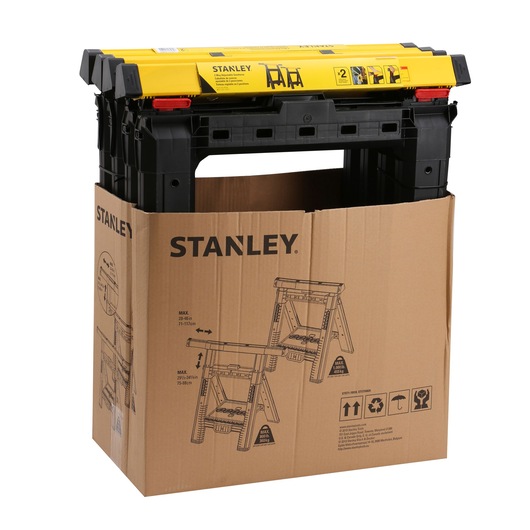 STANLEY STST1-70559 black and yellow plastic sawhorse set in cardboard packaging, front angle.