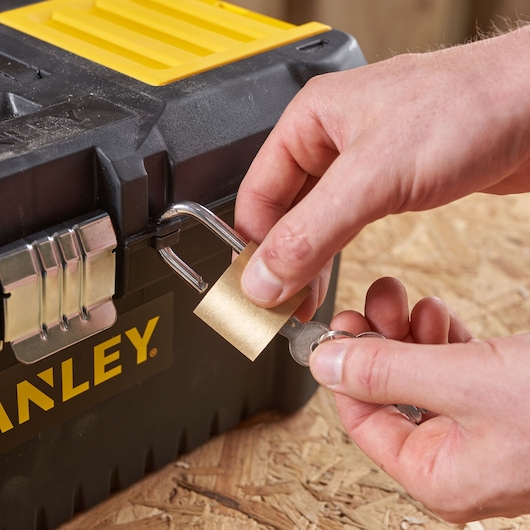 Photo of STANLEY STST1-75518-KR toolbox with padlock being unlocked, close-up view.