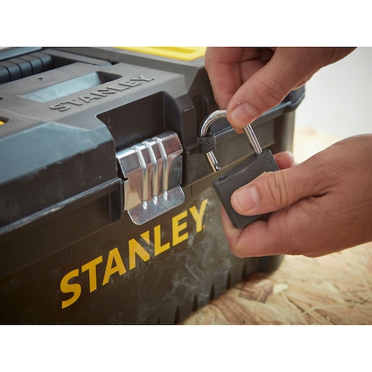 Photo of STANLEY STST1-75518-KR toolbox being locked with a padlock, close-up angle.