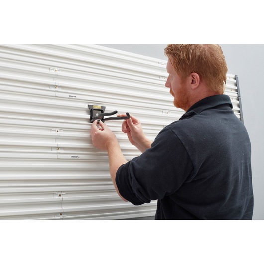 Photo of STANLEY STST82609-1 hook installed on slat wall panel in use, category Photography.