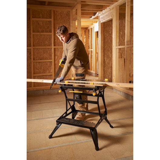 STANLEY STST83800-1 workbench in use at construction site, holding wood plank, photography product category.
