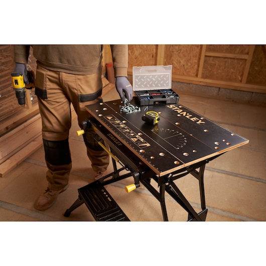 STANLEY STST83800-1 workbench with tools and accessories, angled photo in workshop setting