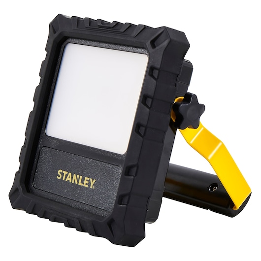 Photo of STANLEY SXLS31329E LED work light with rugged black frame and yellow adjustable stand, angled view.
