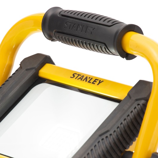STANLEY SXLS31334E portable work light close-up, yellow frame, black handle, white background.