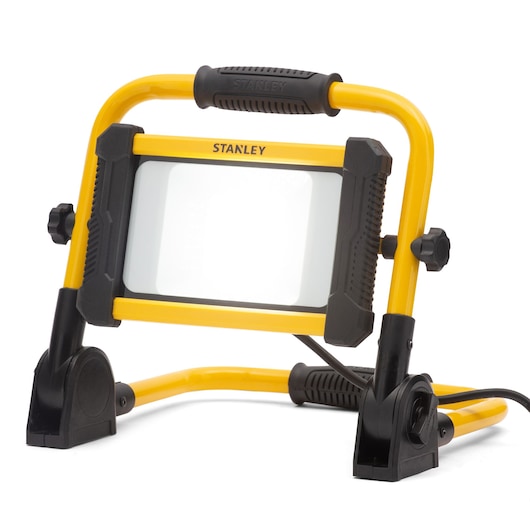 Portable yellow Stanley LED work light with black handle and stand, suitable for photography or jobsite use.