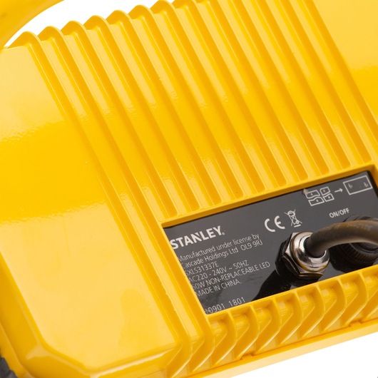 STANLEY SXLS31337E yellow device close-up, showing ribbed surface, label, and power cord on white background.