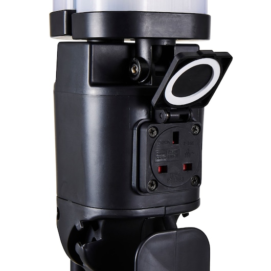 STANLEY SXLS37182E portable lamp base with covered electrical outlet, close-up angle, black matte finish.