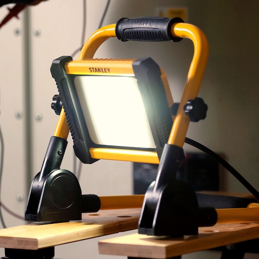 STANLEY SXLS41223E work light with yellow frame and black handle, front angle, photography.