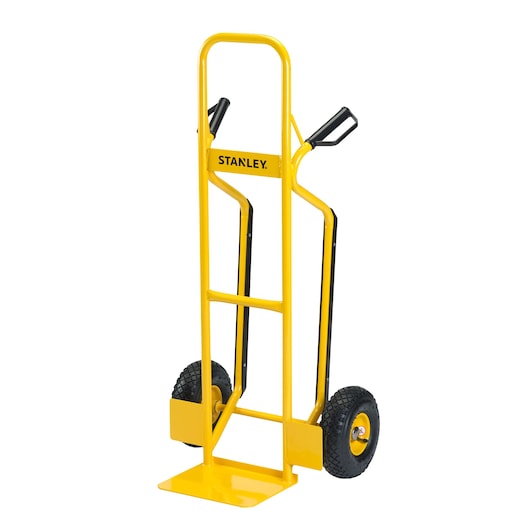 Yellow STANLEY hand truck with two wheels and handles, used for moving heavy items.